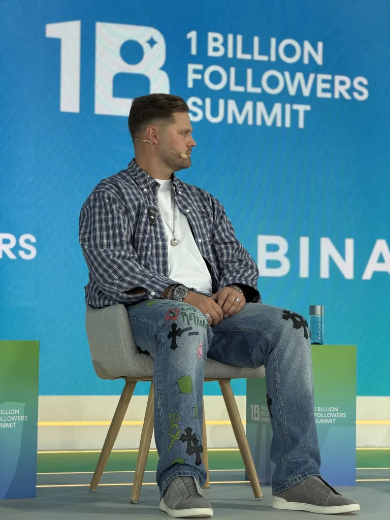 Max Zaharenkov speaking on stage at a Binance event