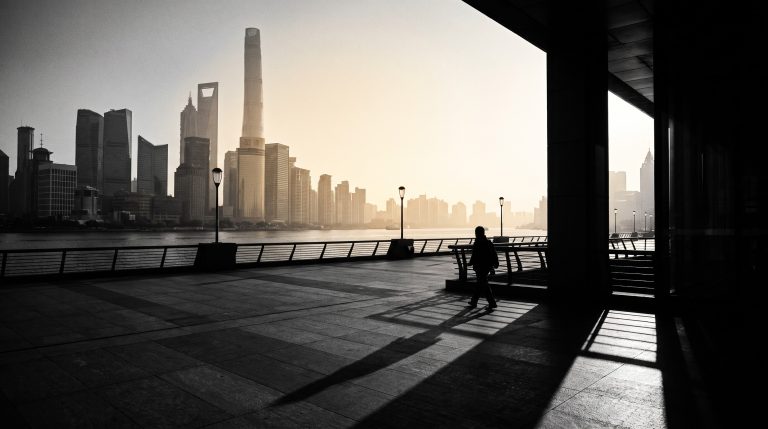 The Bund waterfront in Shanghai at dawn with the Lujiazui skyline across the Huangpu River