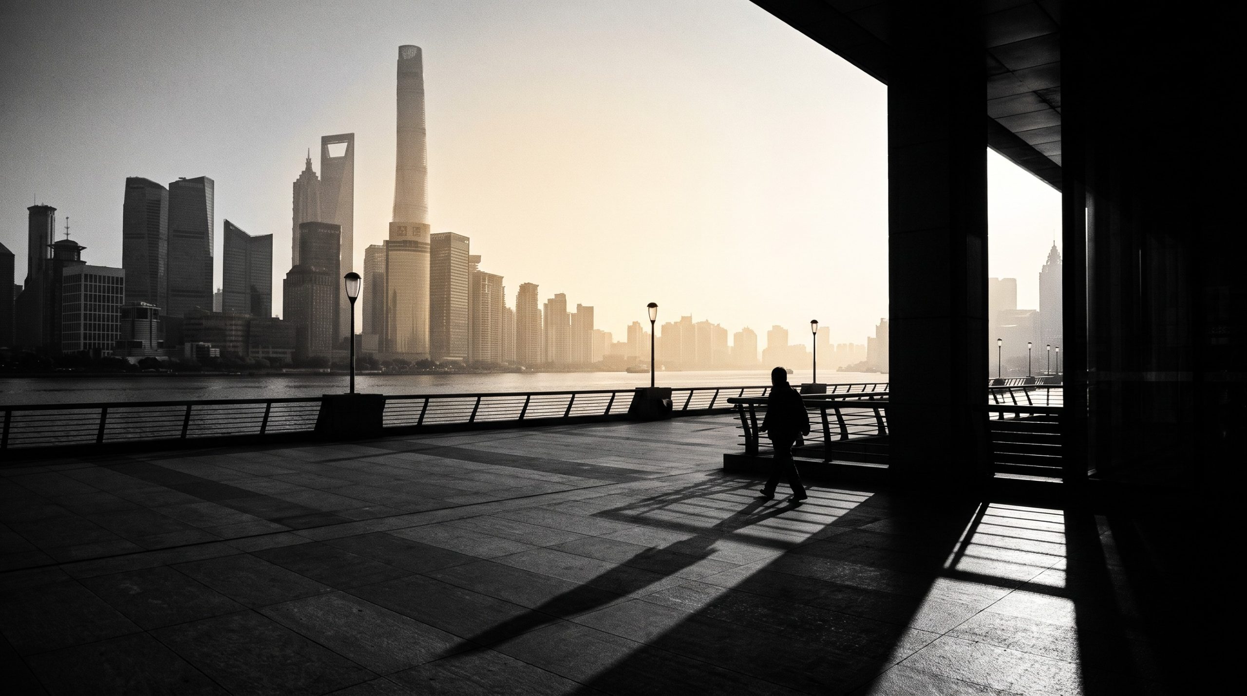 The Bund waterfront in Shanghai at dawn with the Lujiazui skyline across the Huangpu River