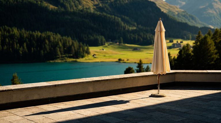 Alpine luxury hotel terrace overlooking Lake St. Moritz in summer