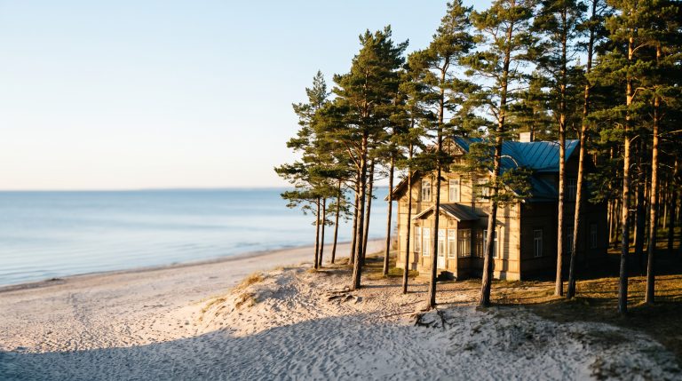 Jurmala beach in Latvia with white sand and pine trees in soft evening light