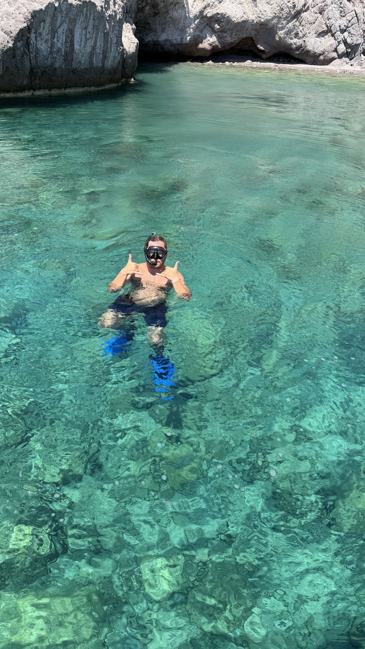 Max Zaharenkov snorkeling in a turquoise cove near Antiparos